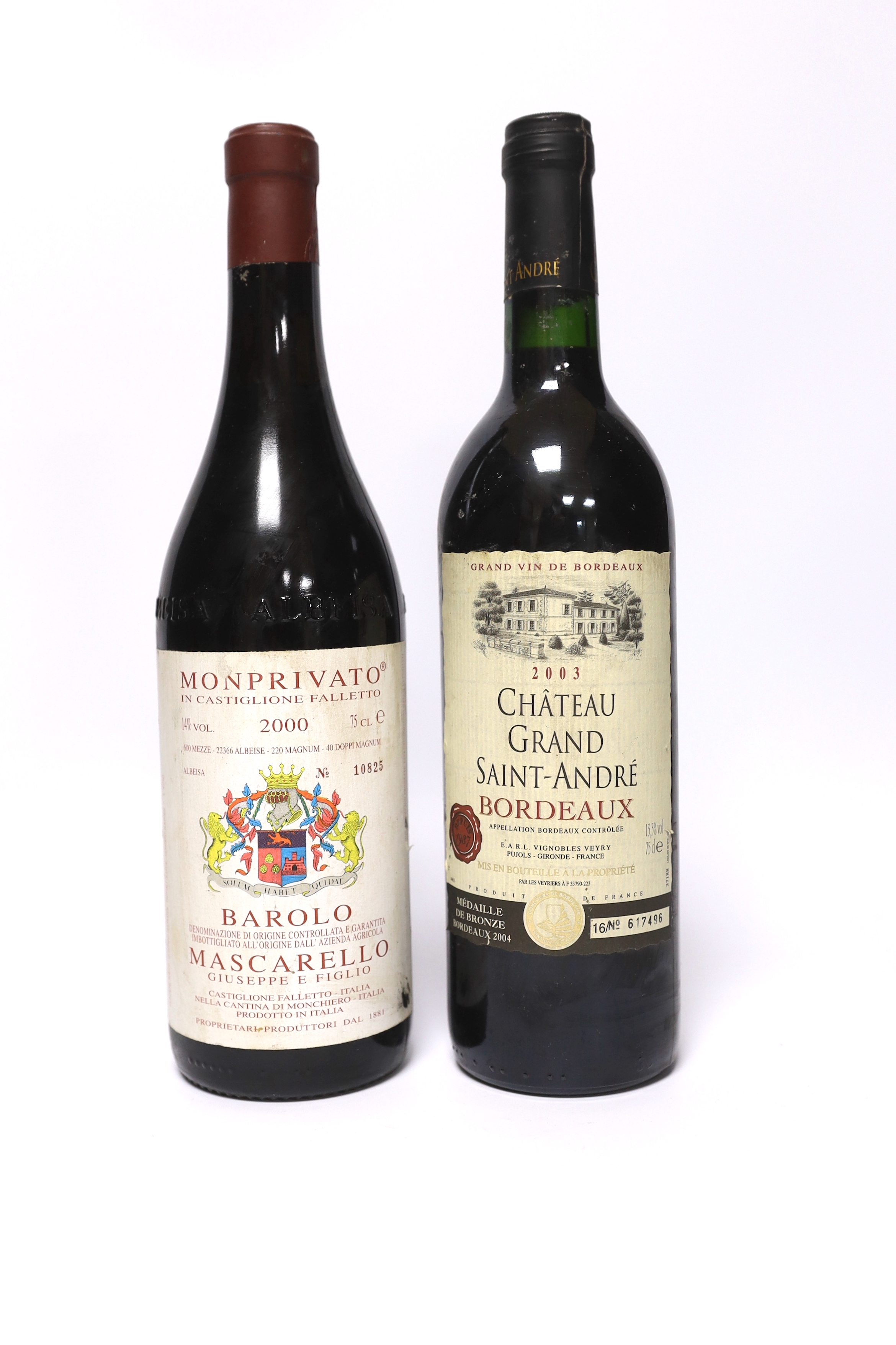 A bottle of Chateau Grand Saint-André Bordeaux 2004 and a bottle of Monprivato Barolo Mascarello 2000